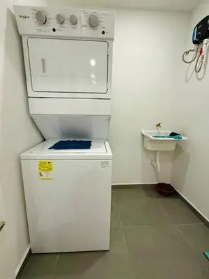 a small kitchen with a stove and a refrigerator at Escalon apartment in San Salvador