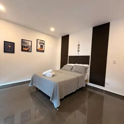 a bedroom with a bed with a table on it at St Michaels Ocean View House in El Zonte