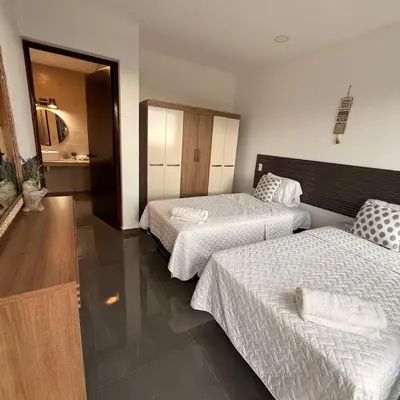 a hotel room with two beds in a room at St Michaels Ocean View House in El Zonte