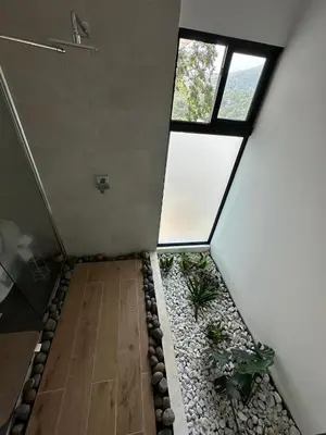 an empty room with a garden in the middle of a house at St Michaels Ocean View House in El Zonte