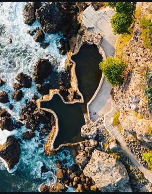 an aerial view of the ocean and rocks at St Michaels Ocean View House in El Zonte