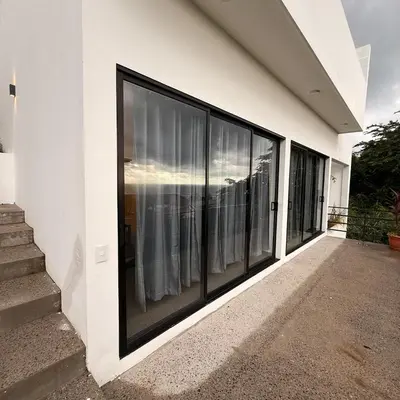 a row of windows on the side of a building at St Michaels Ocean View House in El Zonte