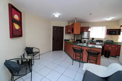 a kitchen with chairs and a counter in a room at Modern Stylish Apt in Secure Area in San Salvador in San Salvador