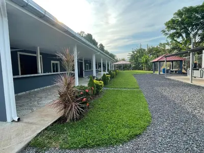 a building with a pathway next to a building with plants at Lodge Ayla Punta Mango in Jucuarán
