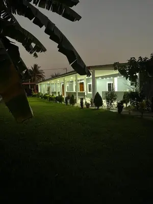 a house with a green lawn in front of it at Lodge Ayla Punta Mango in Jucuarán