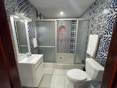 a bathroom with a toilet and a sink and a shower at Lodge Ayla Punta Mango in Jucuarán