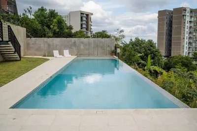 a swimming pool in the middle of a building at Open space concept that allows for multiple places to hang out in San Salvador