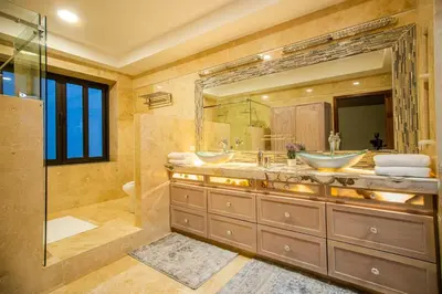 a bathroom with two sinks and a large mirror at Open space concept that allows for multiple places to hang out in San Salvador