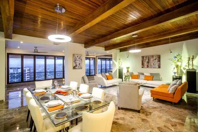 a living room with a table and chairs and a living room at Open space concept that allows for multiple places to hang out in San Salvador