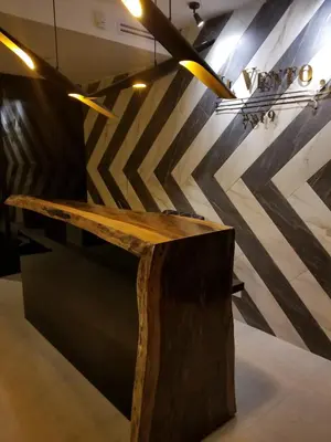 a wooden table in a room with a wall at Open space concept that allows for multiple places to hang out in San Salvador