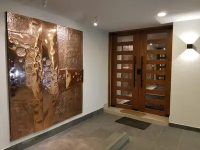 a hallway with a wall mural of wine bottles at Open space concept that allows for multiple places to hang out in San Salvador