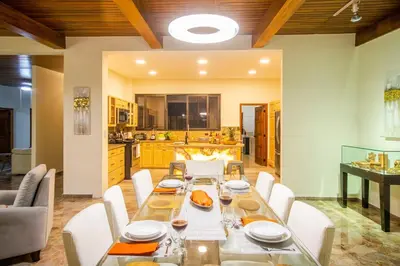 a dining room with a table and chairs and a kitchen at Open space concept that allows for multiple places to hang out in San Salvador