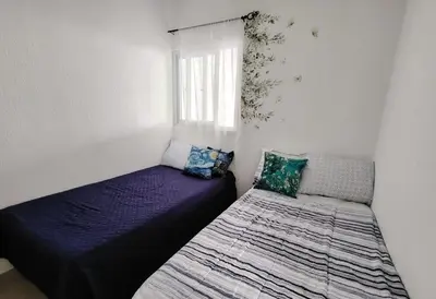 a bedroom with two beds and a window at Susana's house, your home in Ahuachapán in Ahuachapán