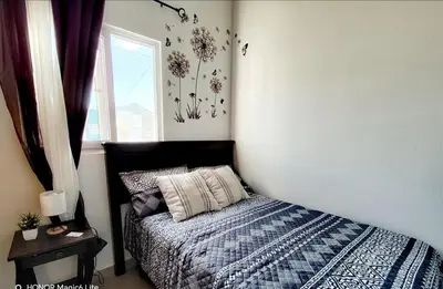 a bedroom with a bed and a window at Susana's house, your home in Ahuachapán in Ahuachapán