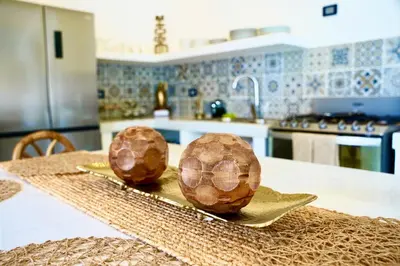 two coconuts on a plate on a table in a kitchen at Villa Nakär - Oceanfront Luxury Villa in Playa Amatecampo, El Salvador in La Esmeralda