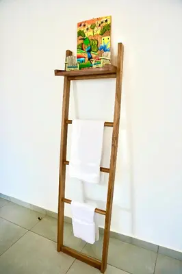 a ladder shelf with towels on it next to a wall at Villa Nakär - Oceanfront Luxury Villa in Playa Amatecampo, El Salvador in La Esmeralda