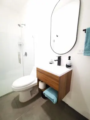 a bathroom with a sink and a toilet and a mirror at Apartamento privado, Miramonte, San Salvador in San Salvador
