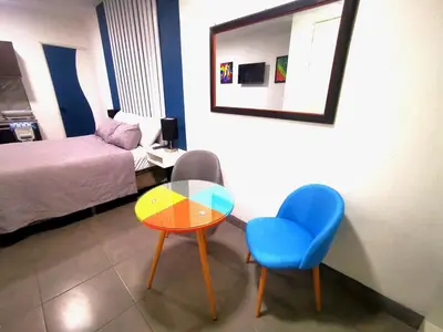 a room with a table and a chair and a bed at Apartamento privado, Miramonte, San Salvador in San Salvador