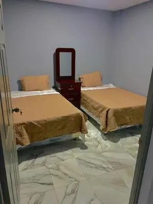 a room with two beds and a mirror on the floor at Palo Coco Home in Santa Ana