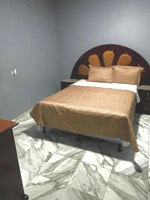 a bedroom with a bed with a wooden headboard at Palo Coco Home in Santa Ana