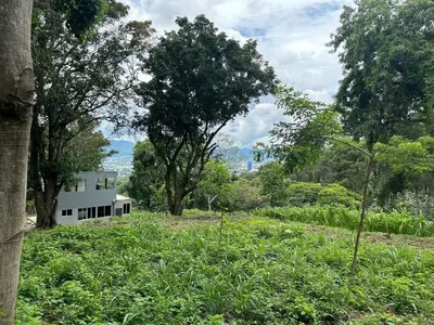 a house in the middle of a field with trees at Zona de Camping con casa de campo in San Salvador