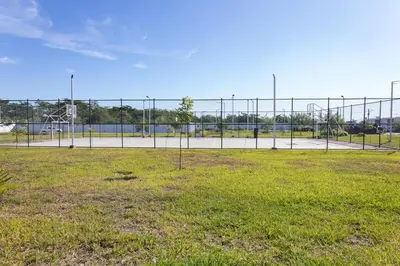 an empty basketball court behind a chain link fence at Casita Marsol in San Miguel in San Miguel