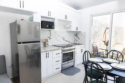 a kitchen with a refrigerator and a table with chairs at Casita Marsol in San Miguel in San Miguel