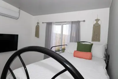 a bedroom with a bed and a window at Casita Marsol in San Miguel in San Miguel