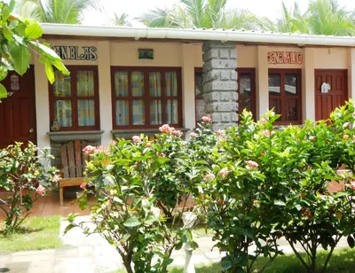 a building with trees in front of it at Punta Roca Surf Resort in La Libertad