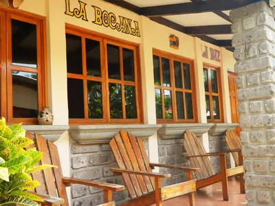 a group of chairs sitting outside of a restaurant at Punta Roca Surf Resort in La Libertad