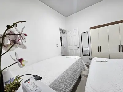 a white room with two beds and a phone at Residence in San Miguel in San Miguel