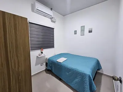 a small room with a bed and a window at Residence in San Miguel in San Miguel