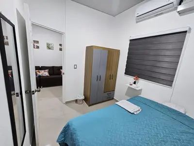 a bedroom with a blue bed in a room at Residence in San Miguel in San Miguel