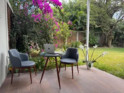 a table and two chairs with a laptop on it at San Benito Executive Suite, luxury, security in San Salvador