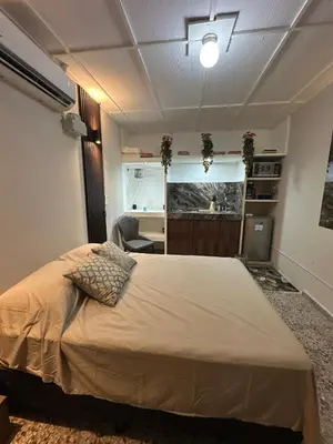 a bedroom with a large bed and a desk at San Benito Executive Suite, luxury, security in San Salvador