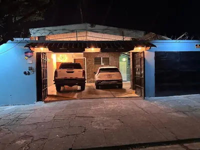 two cars parked in a garage at night at San Benito Executive Suite, luxury, security in San Salvador