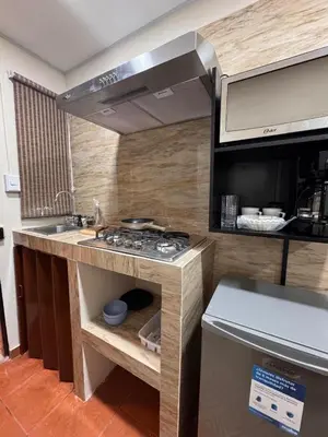 a kitchen with a sink and a stove in it at Oasis Urbano San Benito in San Salvador
