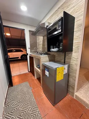 a kitchen with a car parked in a garage at Oasis Urbano San Benito in San Salvador