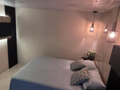 a bedroom with a bed with two pillows on it at Oasis Urbano San Benito in San Salvador