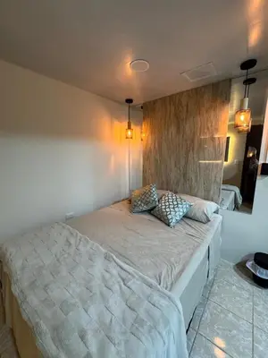 a bedroom with a large bed with two pillows on it at Oasis Urbano San Benito in San Salvador