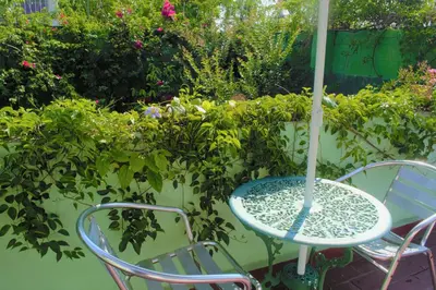 a table and chairs with an umbrella on a patio at Hotel Oasis in San Salvador