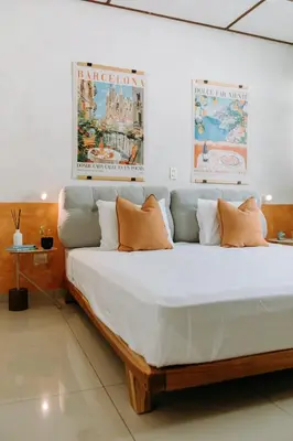 a bedroom with a large white bed with orange pillows at Española - Apartamentos España in San Salvador