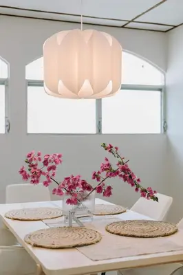 a dining room table with a large light fixture at Española - Apartamentos España in San Salvador