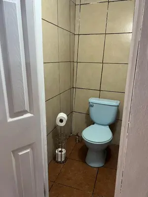 a bathroom with a toilet and a roll of toilet paper at Oli's apartment studio in Mexicanos