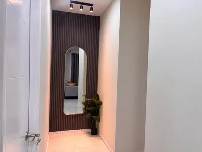 a hallway with a mirror and a bathroom at Apartment in the heart of SA in Santa Ana