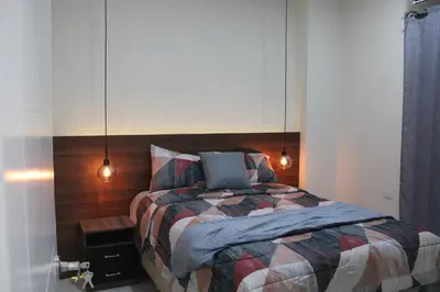 a bedroom with a bed with two pillows on it at Apartment in the heart of SA in Santa Ana