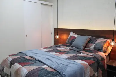 a bedroom with a large bed with two lamps at Apartment in the heart of SA in Santa Ana