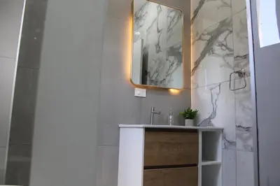 a bathroom with a sink and a mirror at Apartment in the heart of SA in Santa Ana