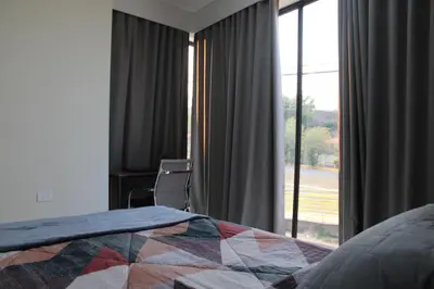 a bedroom with a bed and a large window at Apartment in the heart of SA in Santa Ana