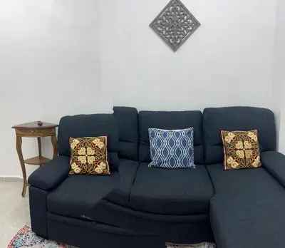 a blue couch with pillows in a living room at Casa de Descanso en la Villa Panamericana in San Miguel